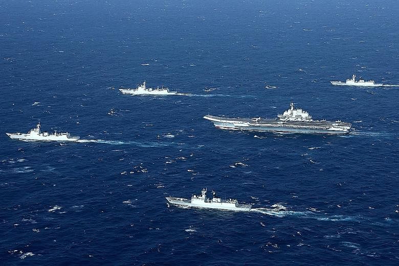China's Liaoning aircraft carrier, with an accompanying fleet, conducting a drill in an area of the disputed South China Sea in December last year. Beijing says that the situation in the area is "calming down" as China and Asean countries have return