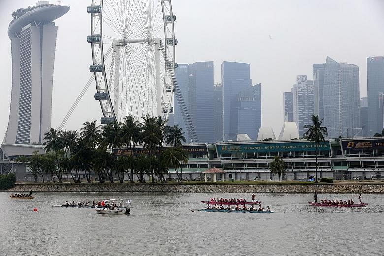 Dragon boaters taking part in a race at the launch of Singapore's month-long celebration of World Water Day at Marina Barrage yesterday. In a Sunday Times poll of 100 respondents, 75 said they did not know how much they spent on water each month.