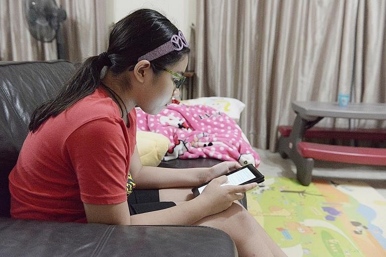 Ten-year-old Emily Selva reading an e-book on her Kindle in the living room of her Woodlands home. She and her younger sister, Calista, eight, get fewer than eight hours of sleep a night due to their busy schedules on school days.