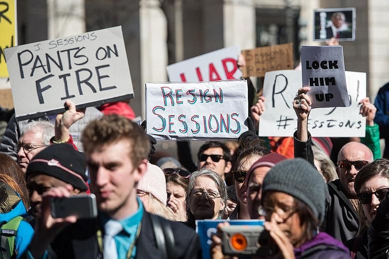 Protesters calling for the resignation of US Attorney-General Jeff Sessions in front of the Justice Department in Washington, DC last Thursday. He came under fire after it was revealed last week that he met Russian Ambassador Sergey Kislyak twice bef