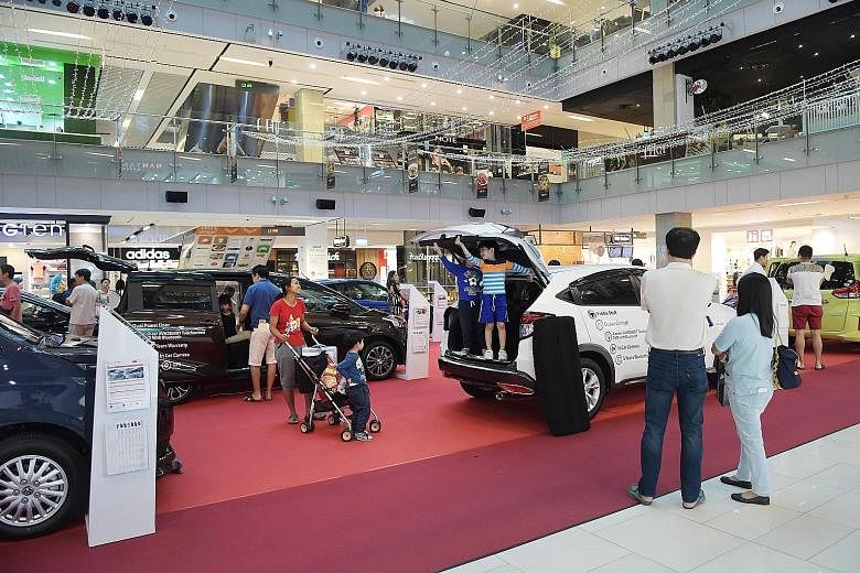 A Venture Cars roadshow at OneKM mall in Katong. The dealership's director says hybrids now make up 60 per cent of its sales.
