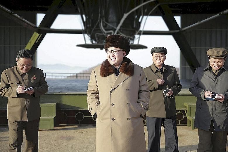 North Korean leader Kim visiting a missile test centre in North Pyongan province last April. Analysts say the engines behind him could power an intercontinental ballistic missile, for which Mr Kim claimed earlier this year that his country is in "fin