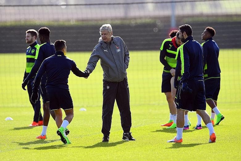 Arsene Wenger shaking hands with Alexis Sanchez before the team's training session at Arsenal's London Colney base. Should the Gunners fail to make up their four-goal deficit against Bayern Munich, they will exit the last-16 stage of the Champions Le