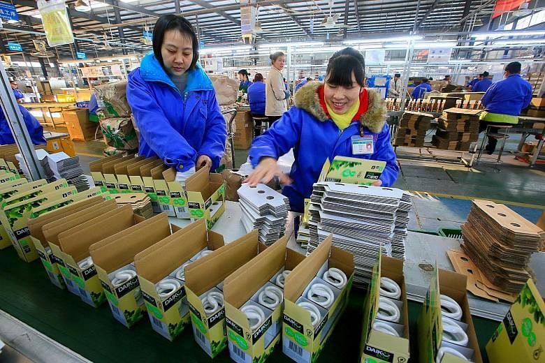 Employees working on an energy-saving bulb production line at a lighting factory in Suining, in China's Sichuan province, last month. While Beijing's plan to increase domestically made products to 70 per cent by 2025 would be a boost to local firms, 