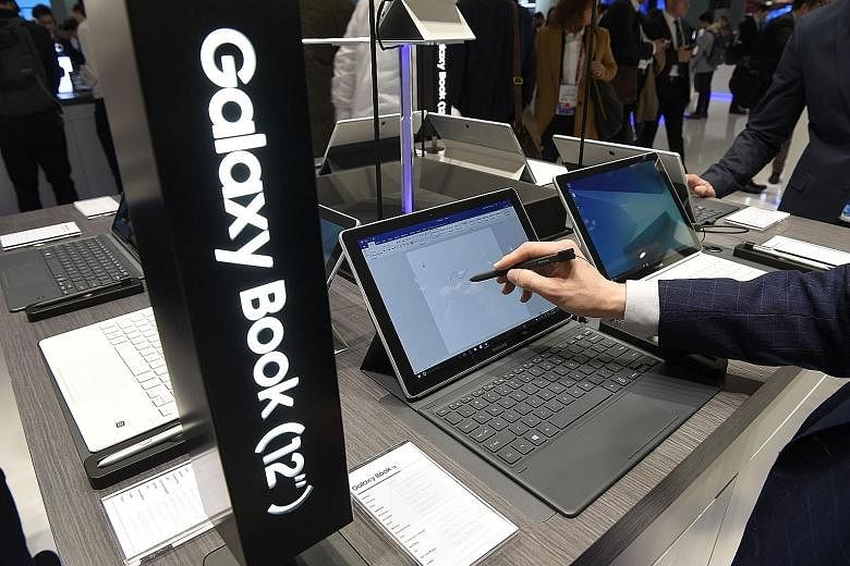 A visitor at the Barcelona show trying out Samsung's Galaxy Book, a tablet-laptop hybrid, which runs on Windows 10.