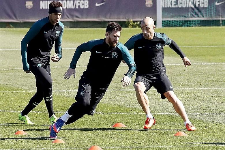 Barcelona players (from left) Neymar, Lionel Messi, and Javier Mascherano training ahead of today's Champions League last-16 second-leg tie against Paris Saint-Germain.