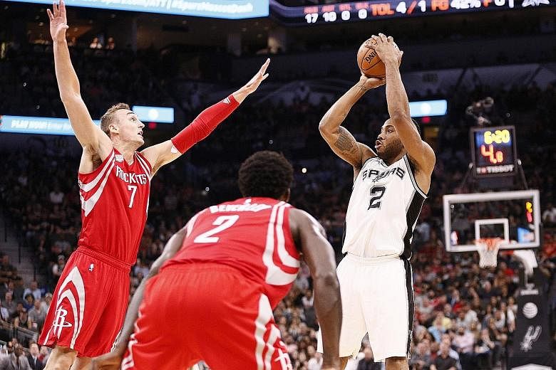San Antonio's Kawhi Leonard shooting over Houston's Sam Dekker during the first half at AT&T Centre. The Spurs won the game 112-110 to record their eighth straight victory.