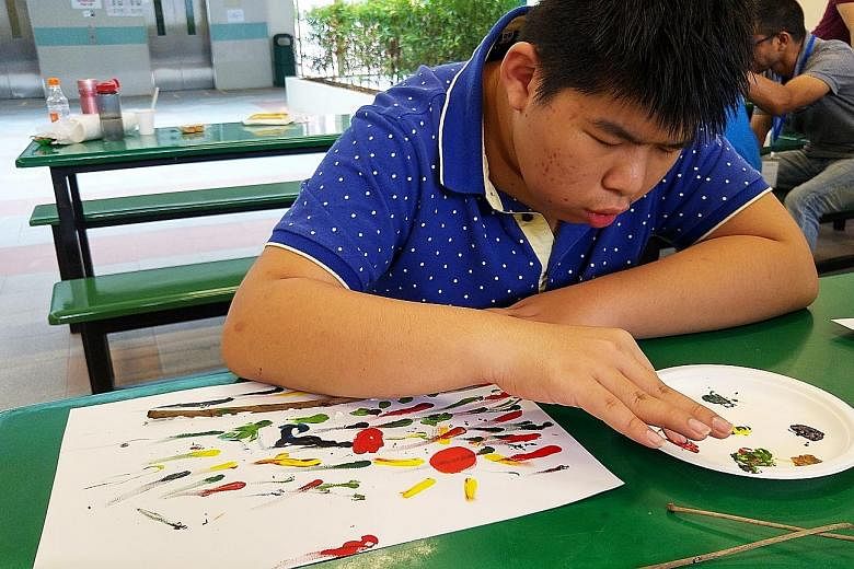 Boon Hong enjoying finger-painting at the headquarters of voluntary welfare organisation AWWA. Caring for the 15-year-old, who has epilepsy, has been exhausting work for his mother. But since last year, she has been getting some respite every Saturda