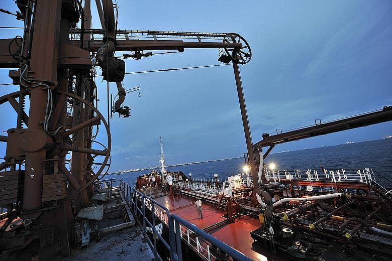 A tanker unloads fuel oil at a power station at a pier in western Singapore. With the International Maritime Organisation's 0.5 per cent cap on sulphur content for marine fuels taking effect in 2020, the shippping industry is expected to use marine g