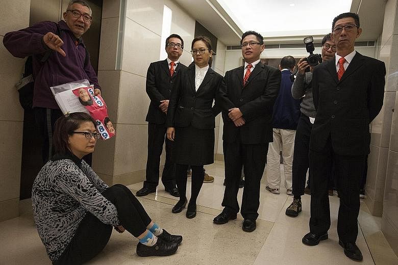 A pro-democracy sit-in during establishment candidate Carrie Lam's visit to the Electoral Affairs Commission last week. Some Hong Kongers object to the lack of universal suffrage in the election.