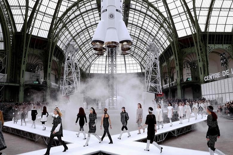 Chanel's collection, featuring glittery fashion from boots to quilted wraps (above), rolls out on a runway with a rocket as the focal point.