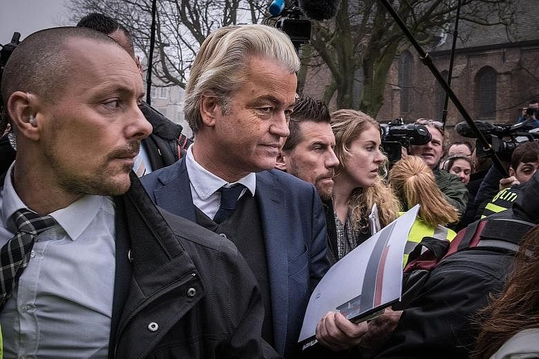 Mr Geert Wilders (second from left), leader of the far-right Party for Freedom, at a campaign stop in Spijkenisse, the Netherlands, on Feb 18. His outspoken anti-European Union and anti-Islam views have attracted so much financial support from like-m
