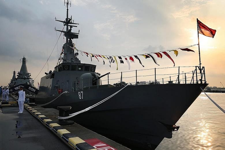 Top: RSS Independence (in front) and LMV Independence (background) at the decommissioning ceremony at Tuas Naval Base yesterday. Above: Singapore Navy sailors bade farewell to the patrol vessel during the ceremony, as flags on the warship were lowere