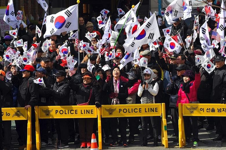 Activists at a rally in Seoul yesterday opposing Ms Park's impeachment.