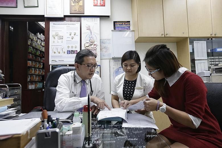 Dr Lee Yik Voon, 54, in discussion with nurse See Chue Win (centre), 33, and care coordinator Landy Lee, 24, yesterday. Dr Lee has been part of the primary care network since late 2015. From next month, GPs will be able to apply to join such a networ