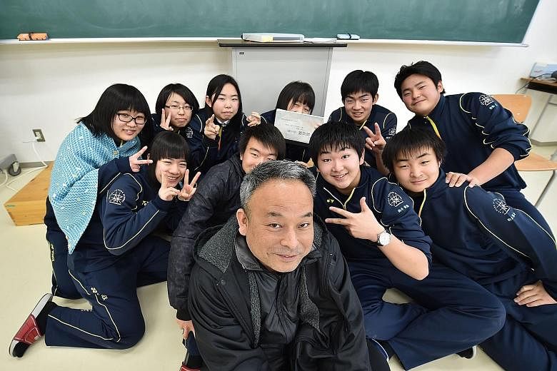 Teacher Shunichi Kobayashi at a school set up primarily for students from nuclear-contaminated areas, with theatre club members who did a play on the 2011 tsunami disaster, to help them cope with the pain.