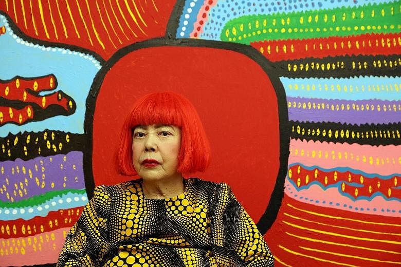 Yayoi Kusama in front of her latest work, Life Is The Heart Of A Rainbow, which will be on display at the National Gallery Singapore exhibition.