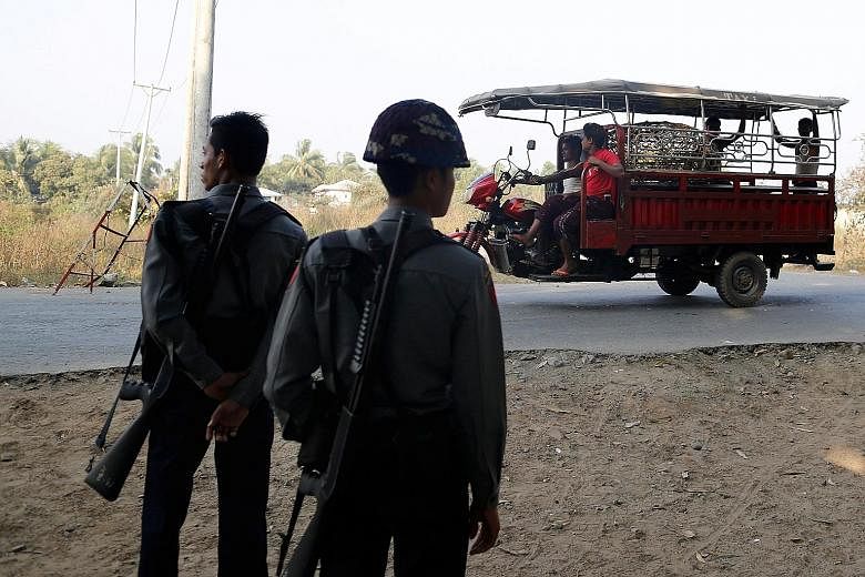 Myanmar police officers at a checkpoint outside a Rohingya refugee camp in Sittwe on March 3. Rakhine state has been plagued by insurgent attacks as well as a military retaliation that may constitute ethnic cleansing.