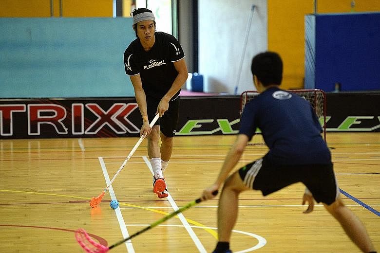 Singapore floorball player Akmal Shaharudin (left) playing in the ActiveSG floorball 3v3 event. The fraternity is hopeful the sport will grow with its incorporation into the fold of ActiveSG academies.