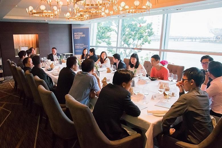 Retail investors who follow the Save & Invest Portfolio Series having lunch with an expert CFA Society Singapore panel and representatives from the Singapore Exchange and The Sunday Times.