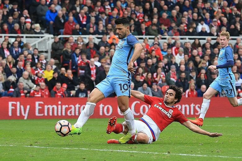 Manchester City's Sergio Aguero evades Middlesbrough defender Fabio da Silva to score his side's second goal off a cross from Leroy Sane in the FA Cup quarter-finals.