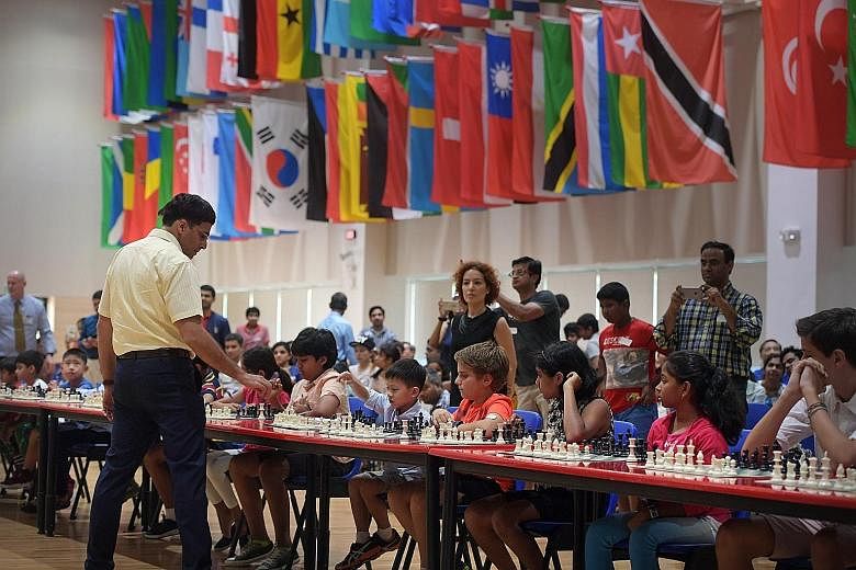 Mr Viswanathan Anand playing in simultaneous chess games against 50 students at Overseas Family School yesterday.