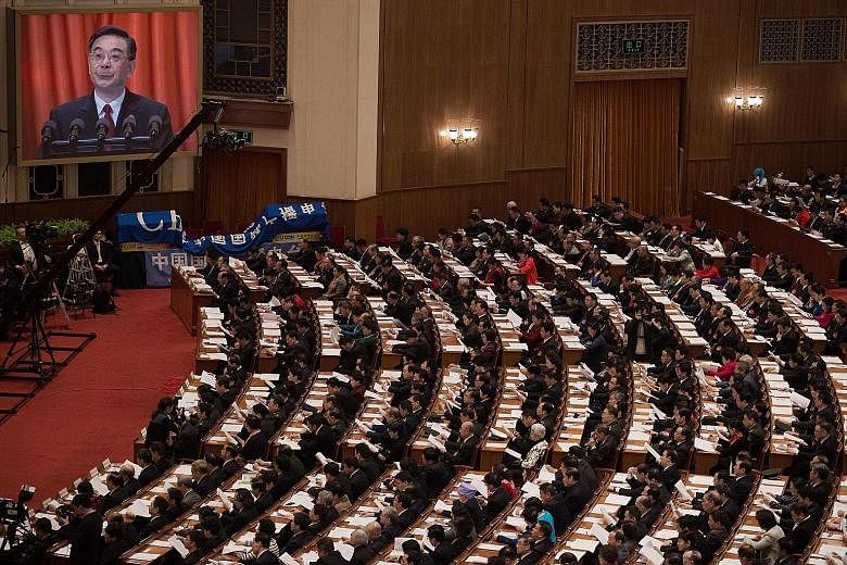 Chief Justice Zhou Qiang giving the report of the Supreme People's Court yesterday. He and Procurator-General Cao Jianming provided updates on the anti-graft situation.