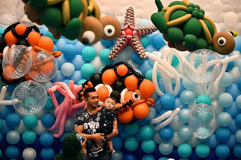 This aquatic wonderland - made with 100,000 inflated balloons - at the Central Atrium of Marina Square was assembled by 45 world-class balloon artists from nine countries. They took four days to complete the display, which features marine creatures s