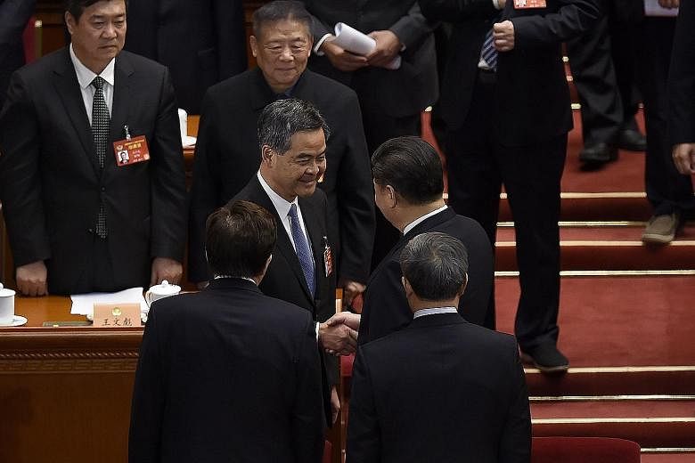 President Xi Jinping (right) congratulating the Hong Kong Chief Executive after he was voted yesterday as vice-chair of the national committee of the Chinese People's Political Consultative Conference.