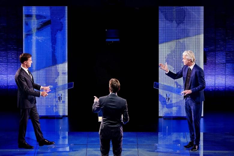 Dutch Prime Minister Rutte (left) facing off against far-right MP Wilders in the televised debate in Rotterdam on Monday.