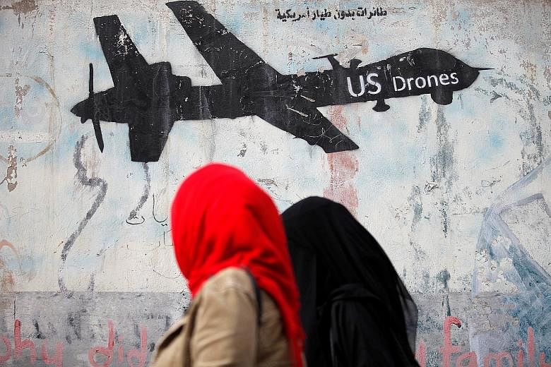 Graffiti denouncing strikes by US drones in Yemen, painted on a wall in Sanaa, Yemen. President Trump has granted a Pentagon request to declare parts of three Yemen provinces as areas with looser battlefield rules.