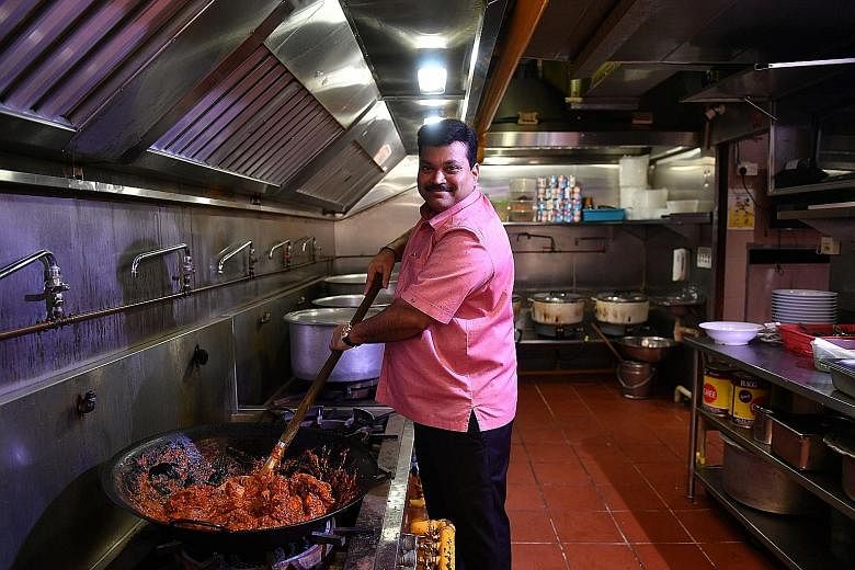 Mr C. Sankaranathan, 45, chief executive officer of The Banana Leaf Apolo, cooking chicken masala at its flagship outlet in Race Course Road. The 43-year-old restaurant, one of the 30 bronze winners in the inaugural Straits Times and Lianhe Zaobao Be
