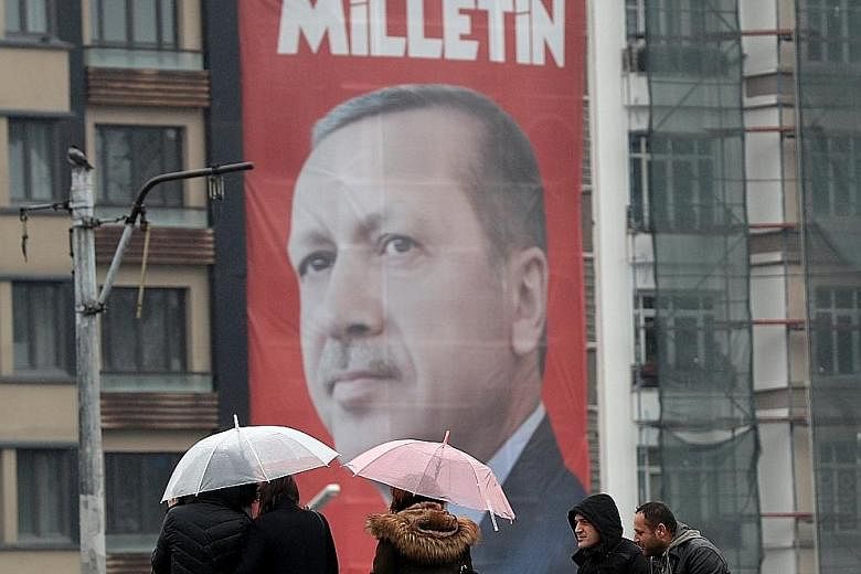 A giant poster of Mr Erdogan in Istanbul's Taksim Square, which reads "Vote yes, only the public can speak and make a decision". A referendum next month seeks to grant him near-absolute power.