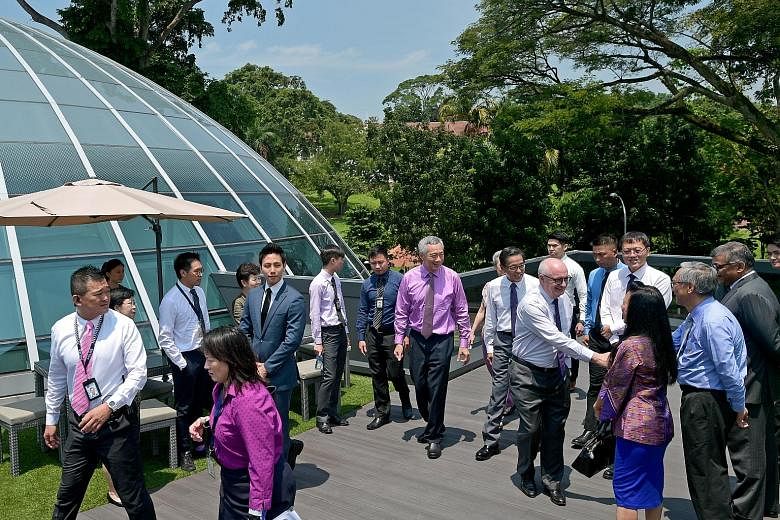 SEE HOME B2 Above: PM Lee outside the Kwa Geok Choo Law Library in SMU yesterday with SMU chairman Ho Kwon Ping and Mrs Lee (blocked). Mr Ho's wife Claire Chiang is with SMU president Arnoud De Meyer and SMU pro-chancellor Lim Chee Onn and Chief Just
