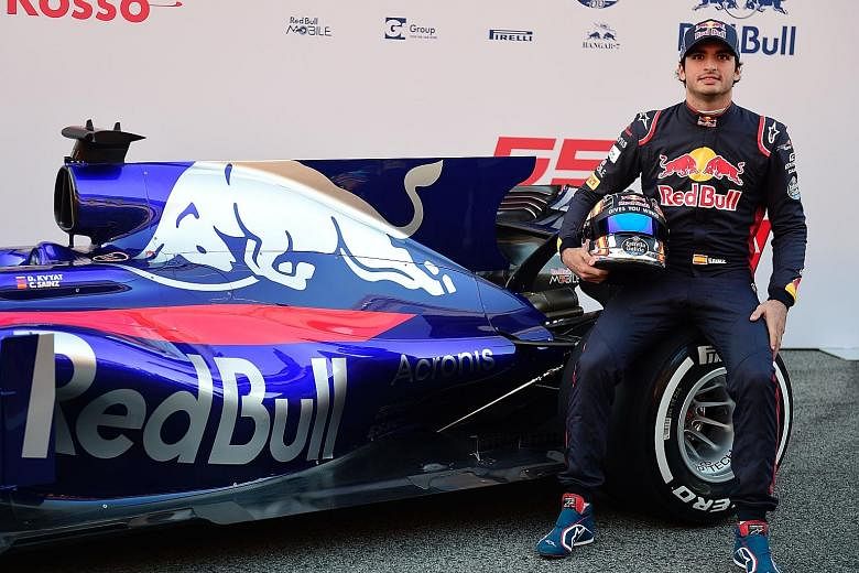 Toro Rosso driver Carlos Sainz with his new STR12 car during the official presentation.