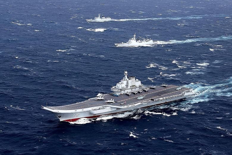 China's Liaoning aircraft carrier with an accompanying fleet conducting a drill in the South China Sea last December. While China aims to achieve primacy in South-east Asia, it is more interested in deepening ties westward. This is reflected in its m