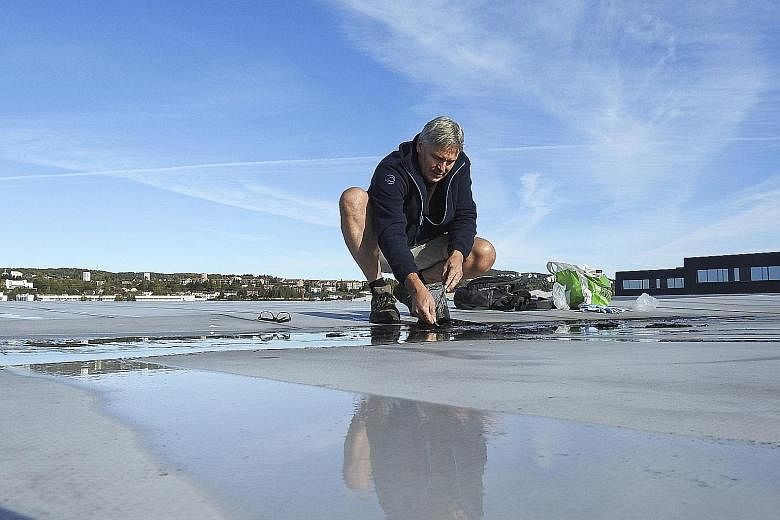 Jazz musician Jon Larsen searching for micrometeorites on a roof. He is part of an international team which found that rooftops and other cityscapes readily collect cosmic debris in ways that can ease its identification. Varieties of extraterrestrial