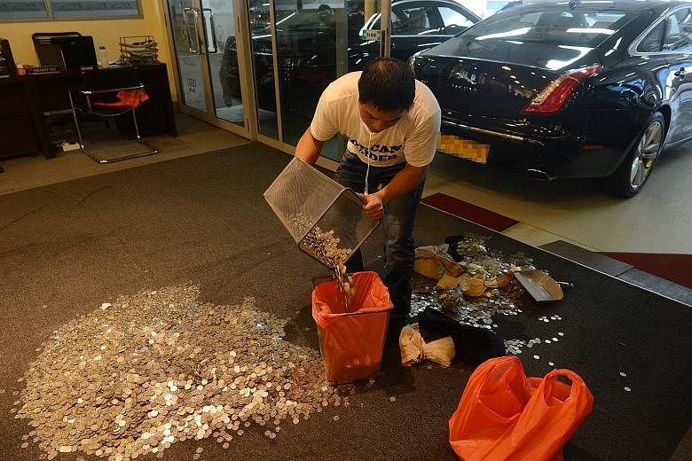 Above: Ms Zhou counting the coins she was given by a mobile phone shop in Sim Lim Square, which had been ordered to refund her $1,000 as well as a $10 administrative fee, in October 2014. Right: An employee of car dealer Exotic Motors collecting the 