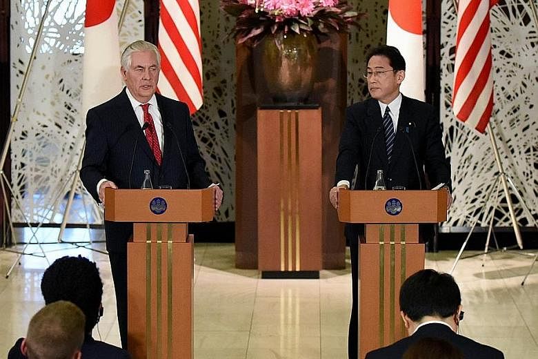 US Secretary of State Tillerson and Japanese Foreign Minister Kishida at a joint news conference in Tokyo yesterday. Mr Tillerson talked of a "new approach" to Pyongyang after two decades of efforts failed to curb its nuclear ambitions.