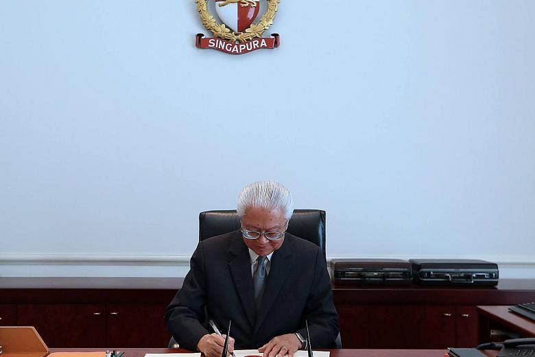 President Tan, seen here signing off on the Budget, said in a Facebook post yesterday that the discretionary power the elected president wields in the Budget process is "a constitutional safeguard".