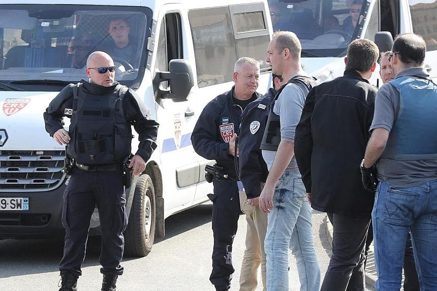 Police officers on foot and in vehicles on alert yesterday in Grasse, where a shooting at a local high school - allegedly carried out by one or more students and targeting the principal - took place earlier.