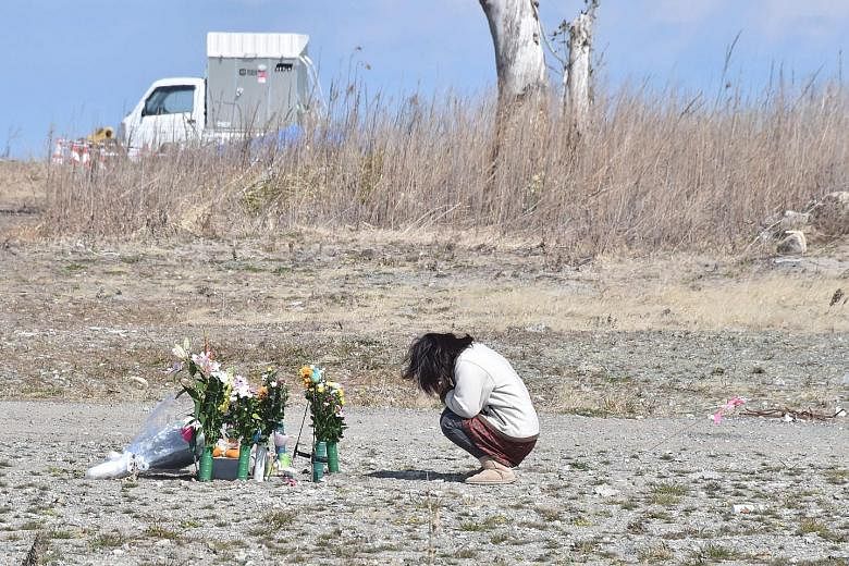 A woman praying for the victims of the disaster in Fukushima last Saturday, the sixth anniversary of the tragedy.
