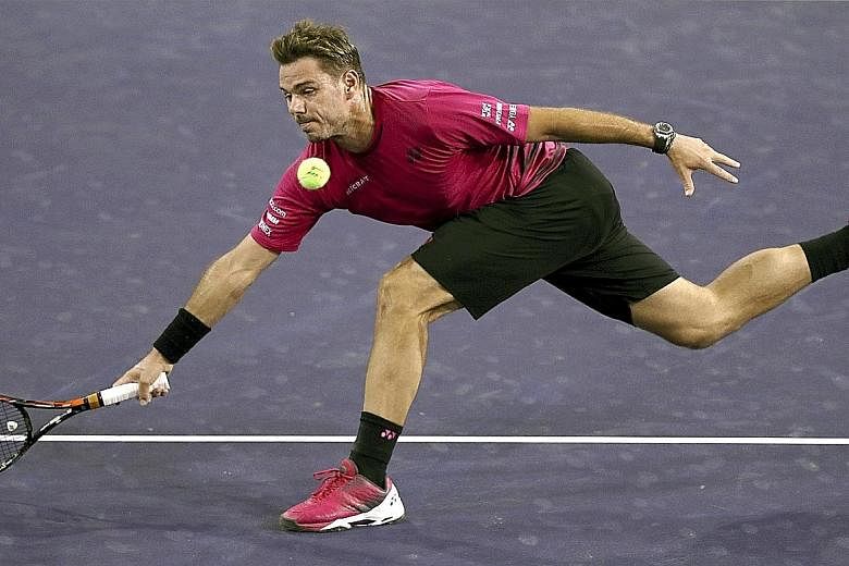 Stan Wawrinka stretching for a return against Austrian Dominic Thiem at Indian Wells, California, during his 6-4, 4-6, 7-6 (7-2) victory. His next opponent is 21st seed Pablo Carreno Busta of Spain.