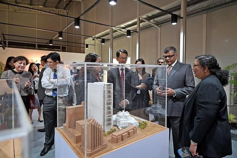 The new State Courts Towers, currently being built, will cost $450 million and are expected to be operational from 2020. Viewing a model of the new State Courts Towers are (from far left) District Judge Wong Peck (partially hidden), Presiding Judge o