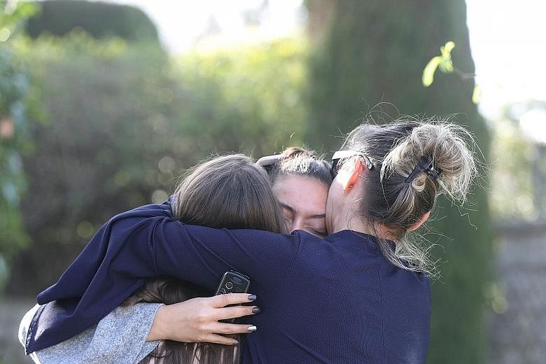 People reacting to the school shooting in Grasse, France, on Thursday. Three students and the principal suffered minor gunshot injuries; another 10 students were treated for shock or injuries from a stampede.