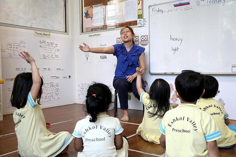 Teacher Connie Heng engages her charges with an activity at Eshkol Valley Preschool. The operator has 20 staff, including 10 teachers, and staff turnover is low.