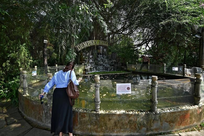 A glass barrier around the turtle pond at Kong Meng San Phor Kark See Monastery (above) stops visitors from throwing things inside, while a sign at a pond in Dempsey Hill (left) urges people not to throw coins into it.