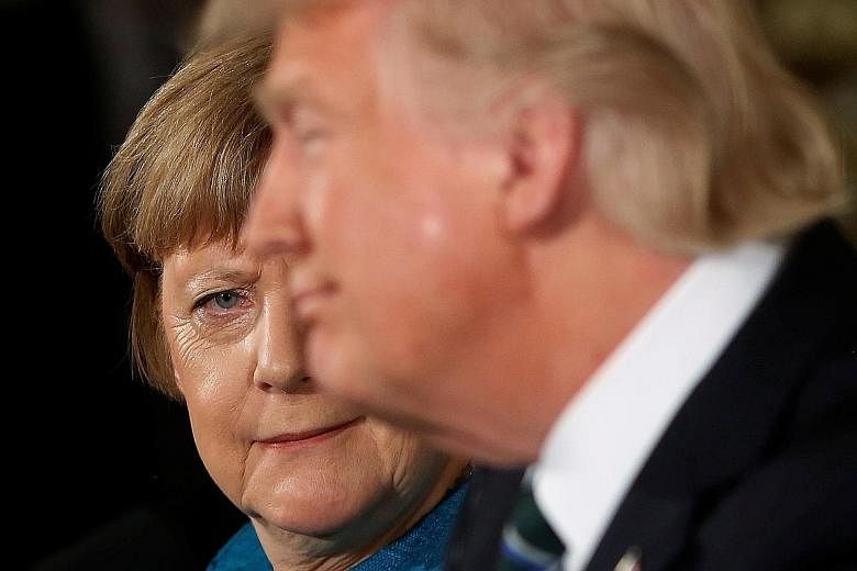 Germany's Chancellor Angela Merkel giving US President Donald Trump a look after he quipped how they might have both been wiretapped by his predecessor Barack Obama, during their joint news conference on Friday. The Obama administration's spying infu