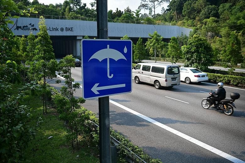 A rain shelter sign along the Bukit Timah Expressway (BKE). A rain shelter for motorcyclists on the BKE, one of 80 at the 10 expressways here. Such shelters are marked by umbrella signs and demarcated by vehicle impact guard rails or spring-loaded po