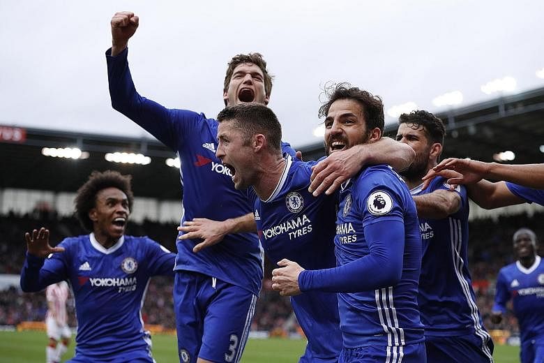 Chelsea players huddling around defender Gary Cahill after his 87th-minute winner as the Blues scraped a 2-1 win over Stoke, despite not being at their best and shorn of their best player in midfielder Eden Hazard. Chelsea next play Crystal Palace at